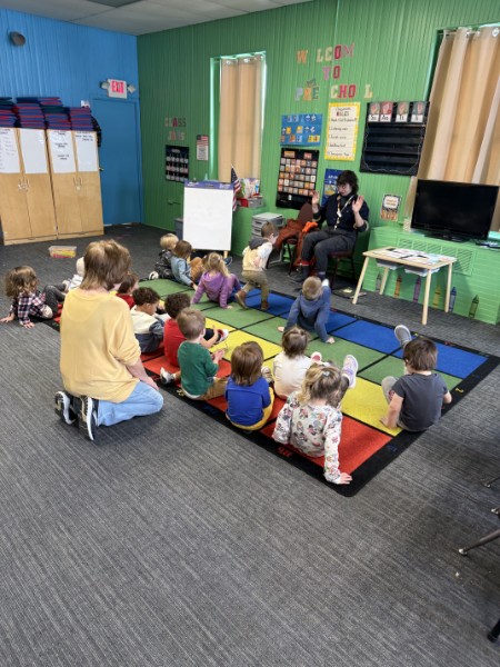Guest reader visiting the 3s class