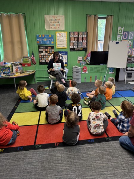 Preschool class listening during library reading