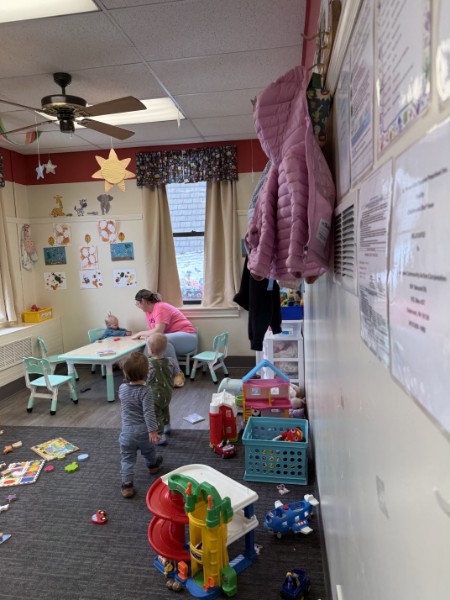 Ms. Julie with the younger toddlers at the activity table